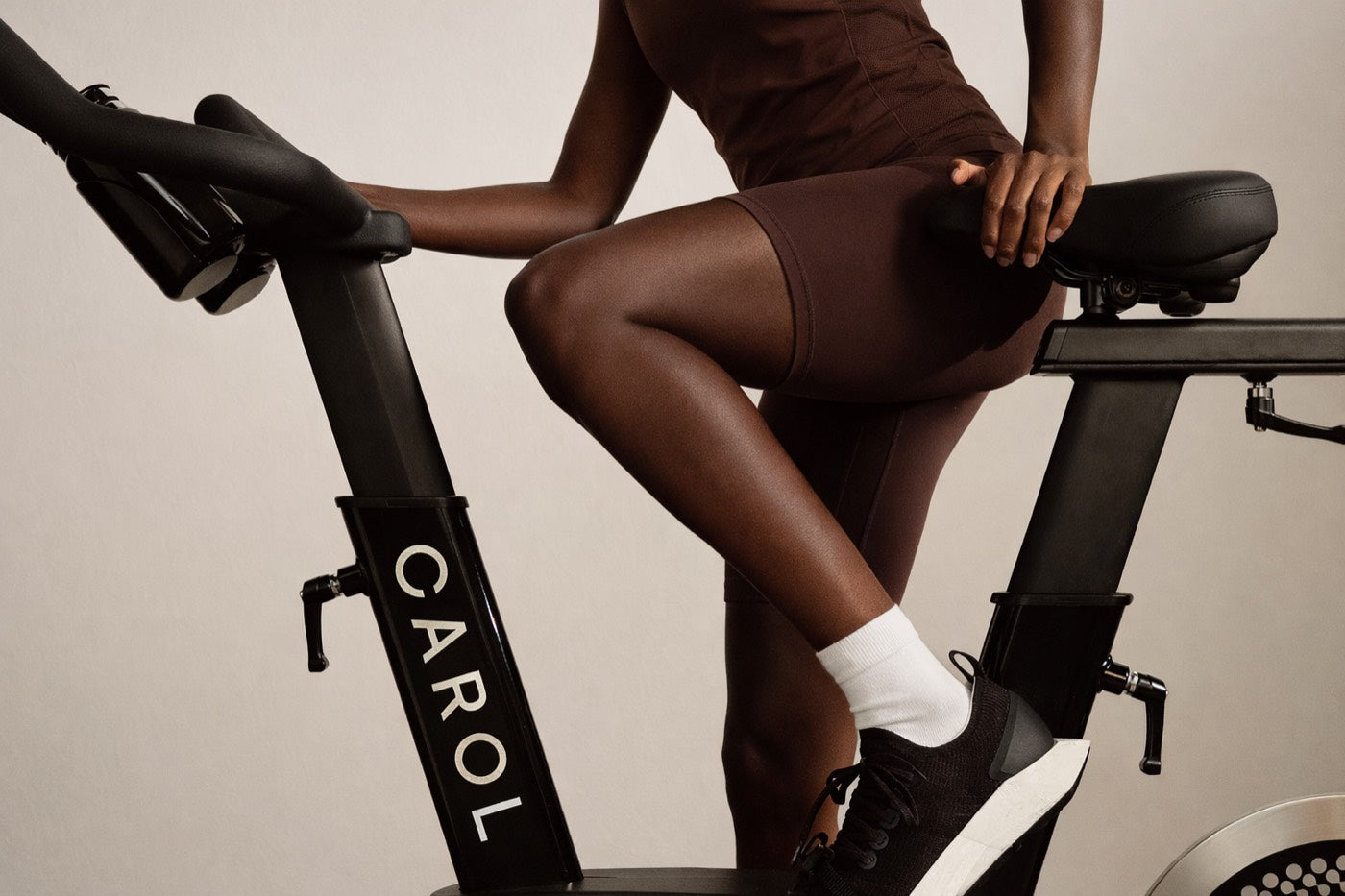 Close view of a rider's legs turning the pedals, CAROL Bike frame in profile