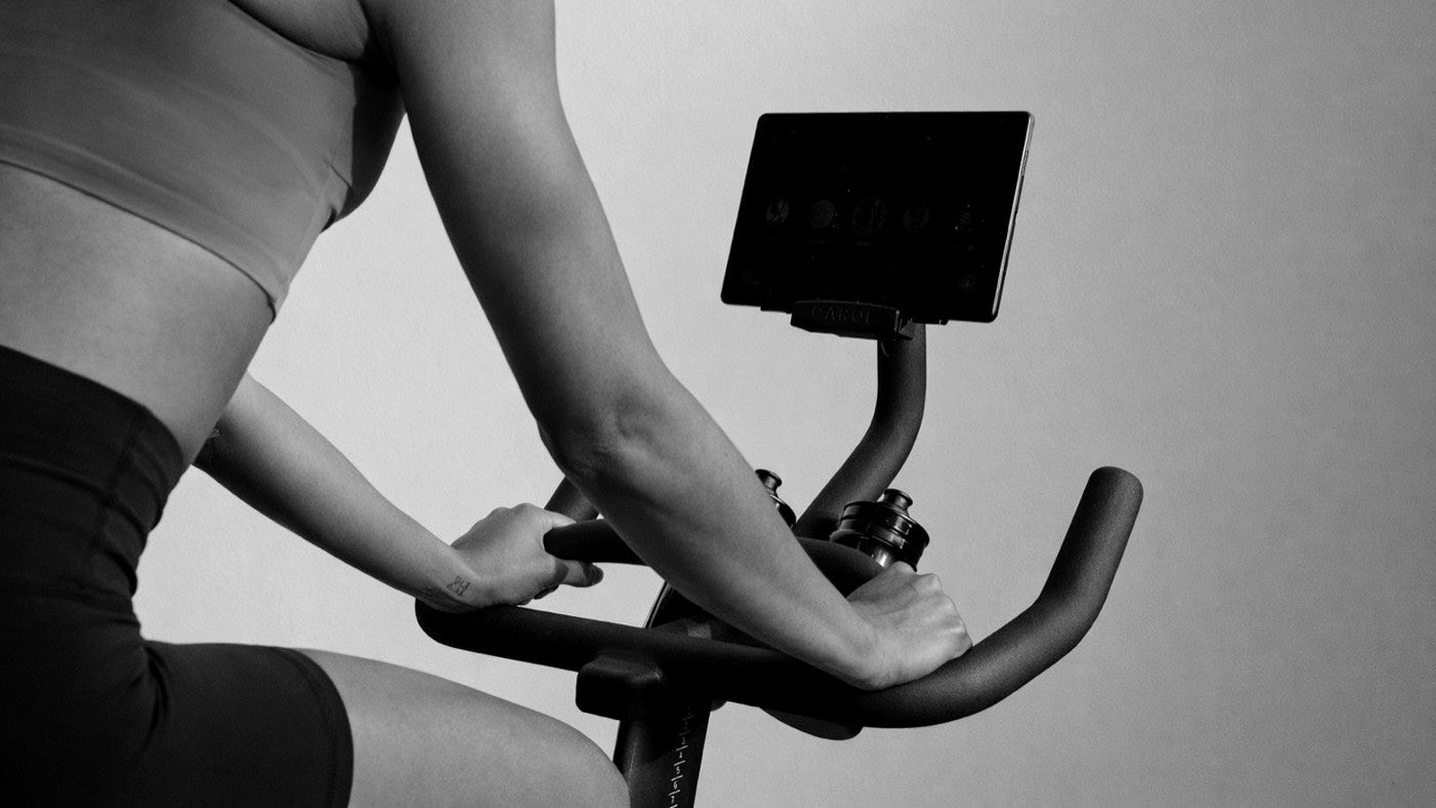 Close view of a rider gripping the CAROL Bike handlebars, forearm engaged
